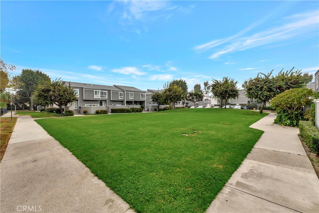 2670 West Segerstrom Avenue, Unit F Santa Ana, CA 92704 - Photo 25 of 28 a view of yard with swimming pool and green space