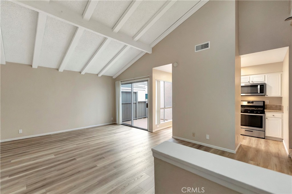 2670 West Segerstrom Avenue, Unit F Santa Ana, CA 92704 - Photo 3 of 28 a view of a kitchen with an empty space and a window