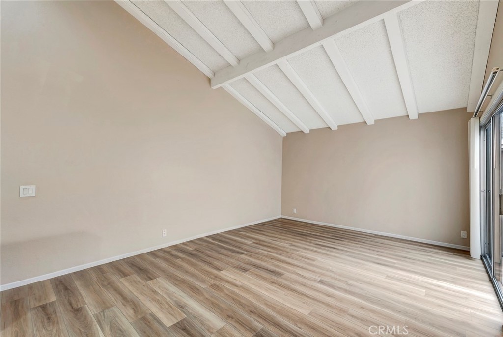 2670 West Segerstrom Avenue, Unit F Santa Ana, CA 92704 - Photo 7 of 28 a view of empty room with wooden floor