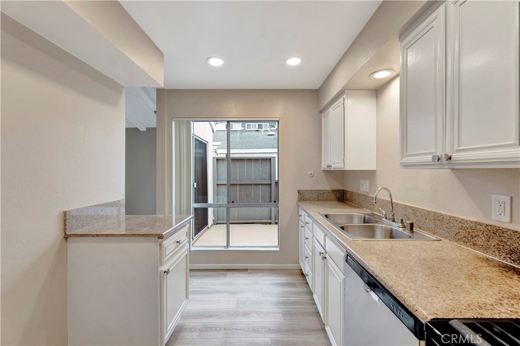 2670 West Segerstrom Avenue, Unit F Santa Ana, CA 92704 - Photo 10 of 28 a kitchen with granite countertop a sink and cabinets