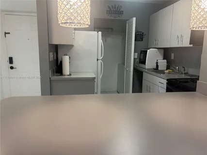 a kitchen with refrigerator and window