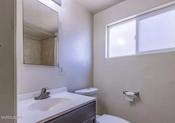 a bathroom with a sink toilet and mirror