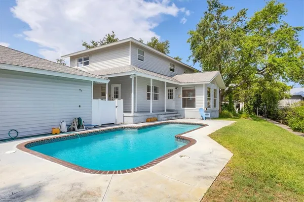 a view of a house with swimming pool and porch