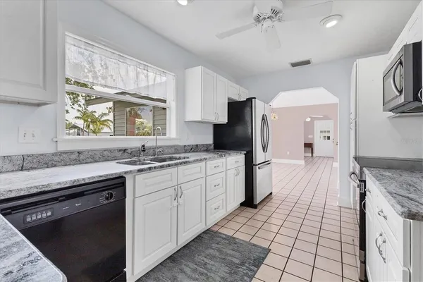 a kitchen with a sink stove and refrigerator