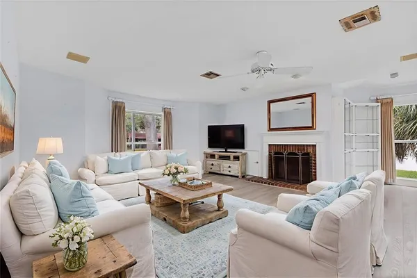 a living room with furniture a fireplace and a flat screen tv