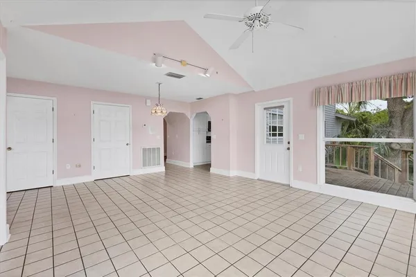 wooden floor fireplace and windows in an empty room
