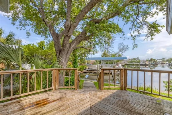 a view of a wooden deck with a lake view