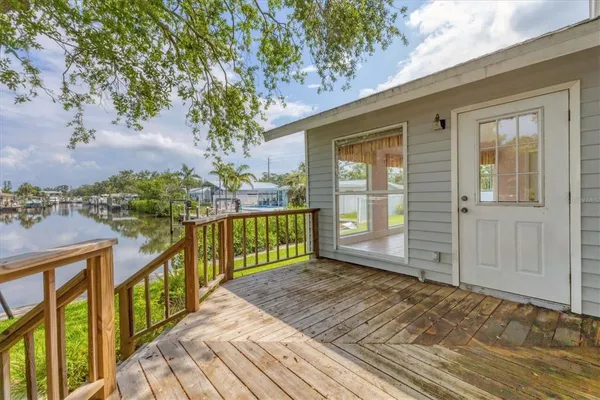 a view of balcony with wooden floor and fence