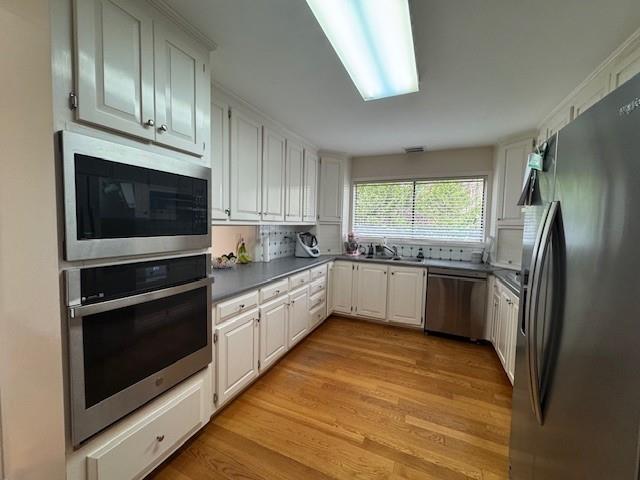 192 Kings Row Northeast Marietta, GA 30067 - Photo 5 of 34 a kitchen with stainless steel appliances kitchen island granite countertop a stove a microwave and a refrigerator