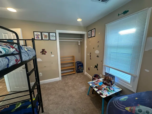 a view of a livingroom with furniture and hardwood floor