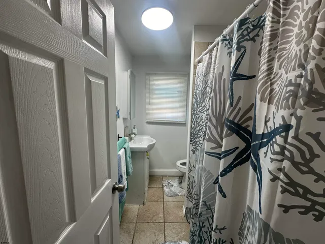 a view of a livingroom with furniture and staircase