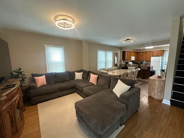 a living room with furniture and wooden floor