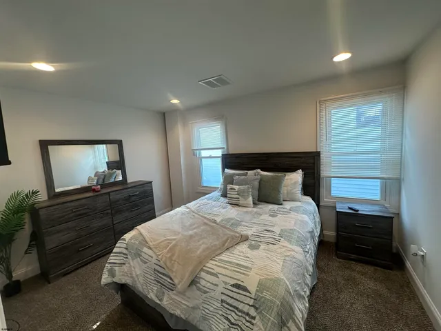 a bed room with a bed and a dresser