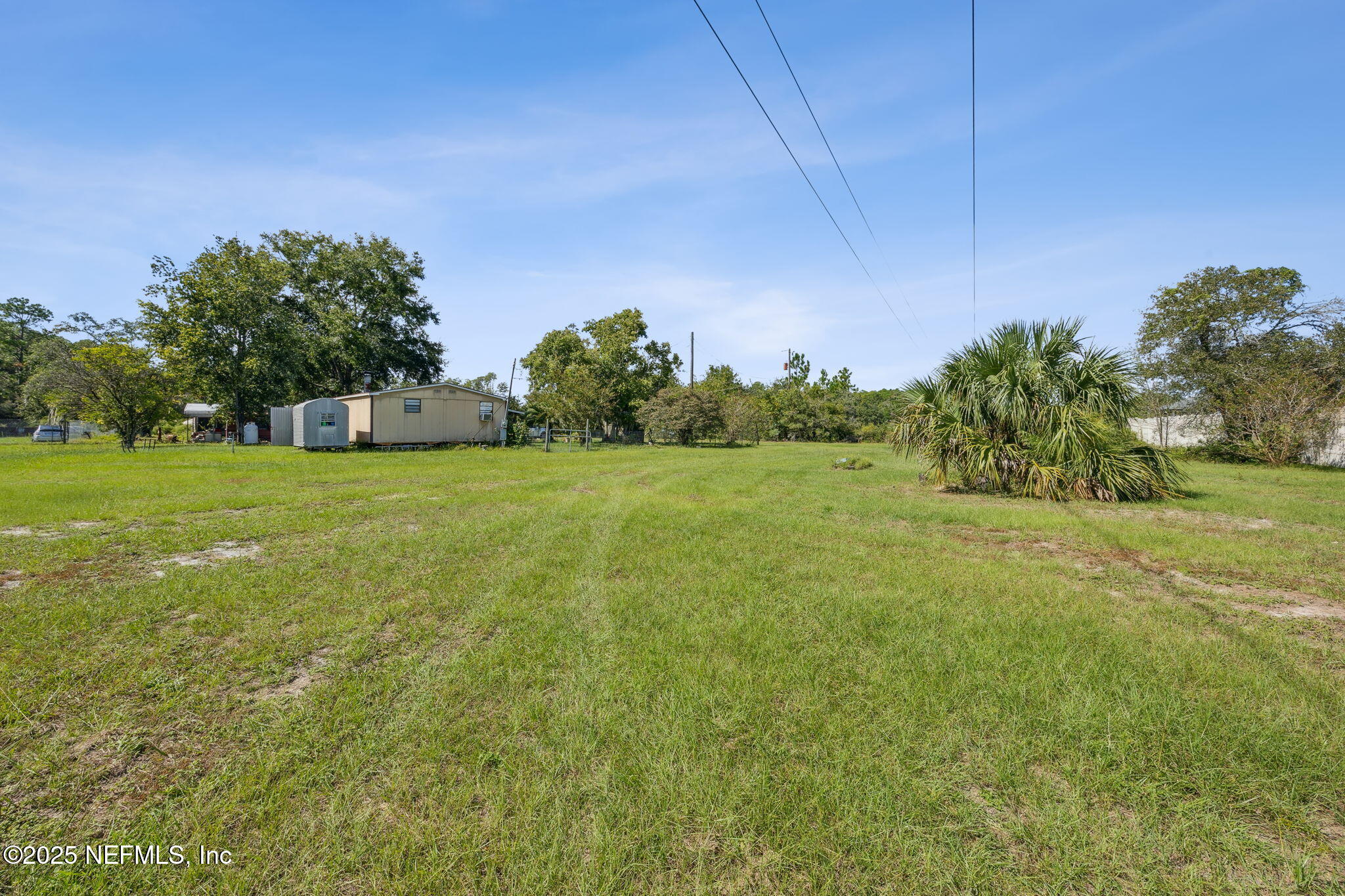 86158 Overstreet Lane Yulee, FL 32097 - Photo 2 of 25 a view of a field with trees in the background
