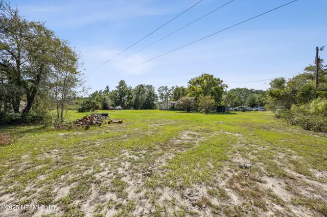 a view of a field with trees in the background