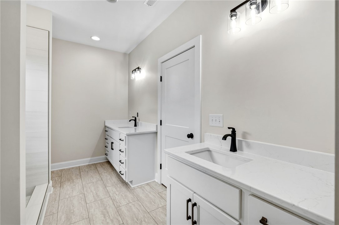 1735 Maw Bridge Road Central, SC 29630 - Photo 21 of 38 This serene bathroom offers dual vanities, perfect for effortless morning routines.