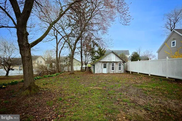 a view of large house with a big yard and large trees