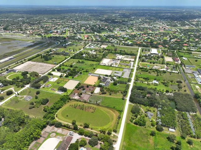 an aerial view of a residential houses with outdoor space and street view