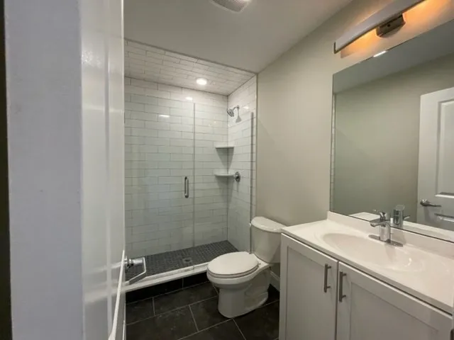 a bathroom with a sink toilet a mirror and shower