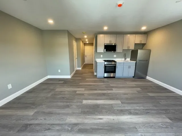 a view of a kitchen with a sink and a stove top oven