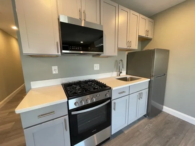 a kitchen with a stove and a microwave