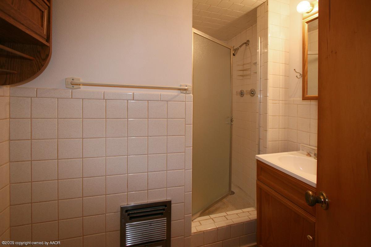 4318 South Ong Street Amarillo, TX 79110 - Photo 3 of 14 a bathroom with a shower and a sink