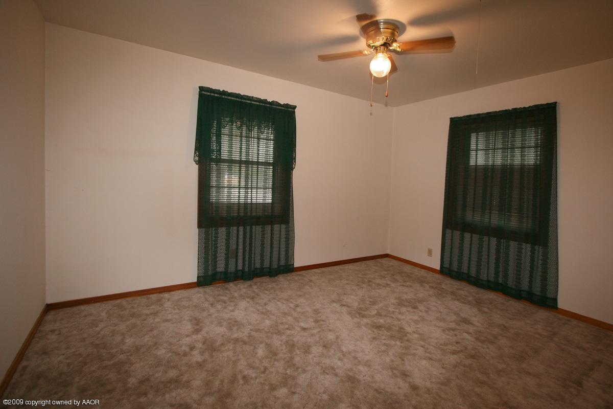 4318 South Ong Street Amarillo, TX 79110 - Photo 6 of 14 en empty room with windows and ceiling fan