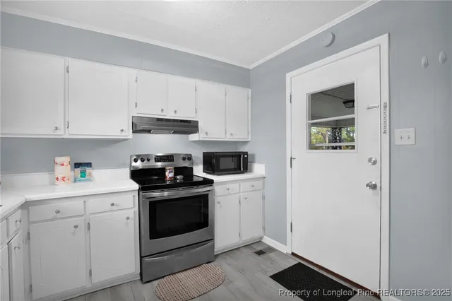a kitchen with cabinets stainless steel appliances and a counter space