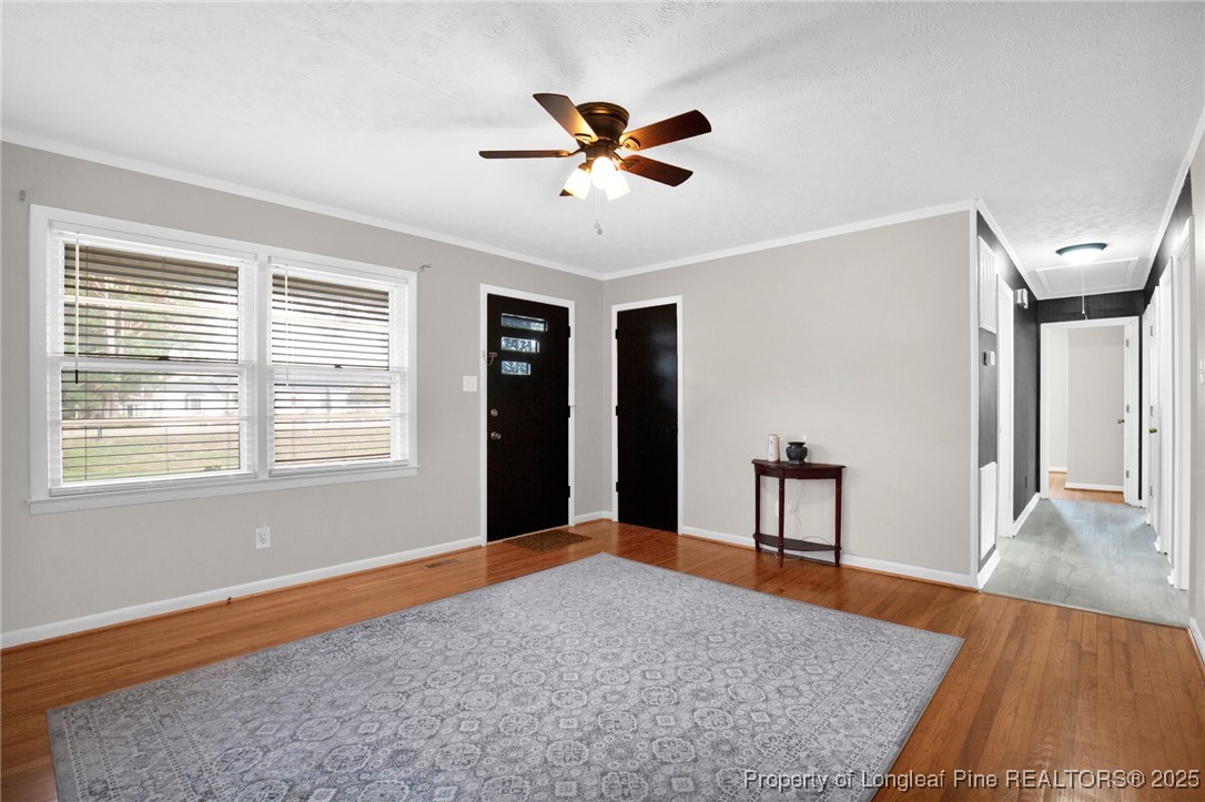 623 Isaac Weeks Road Clinton, NC 28328 - Photo 7 of 24 a workspace with wooden floor and a ceiling fan