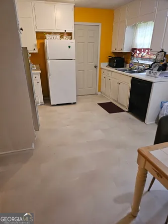 a kitchen with cabinets and white appliances