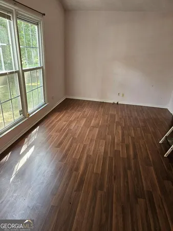 wooden floor in a room next to a window