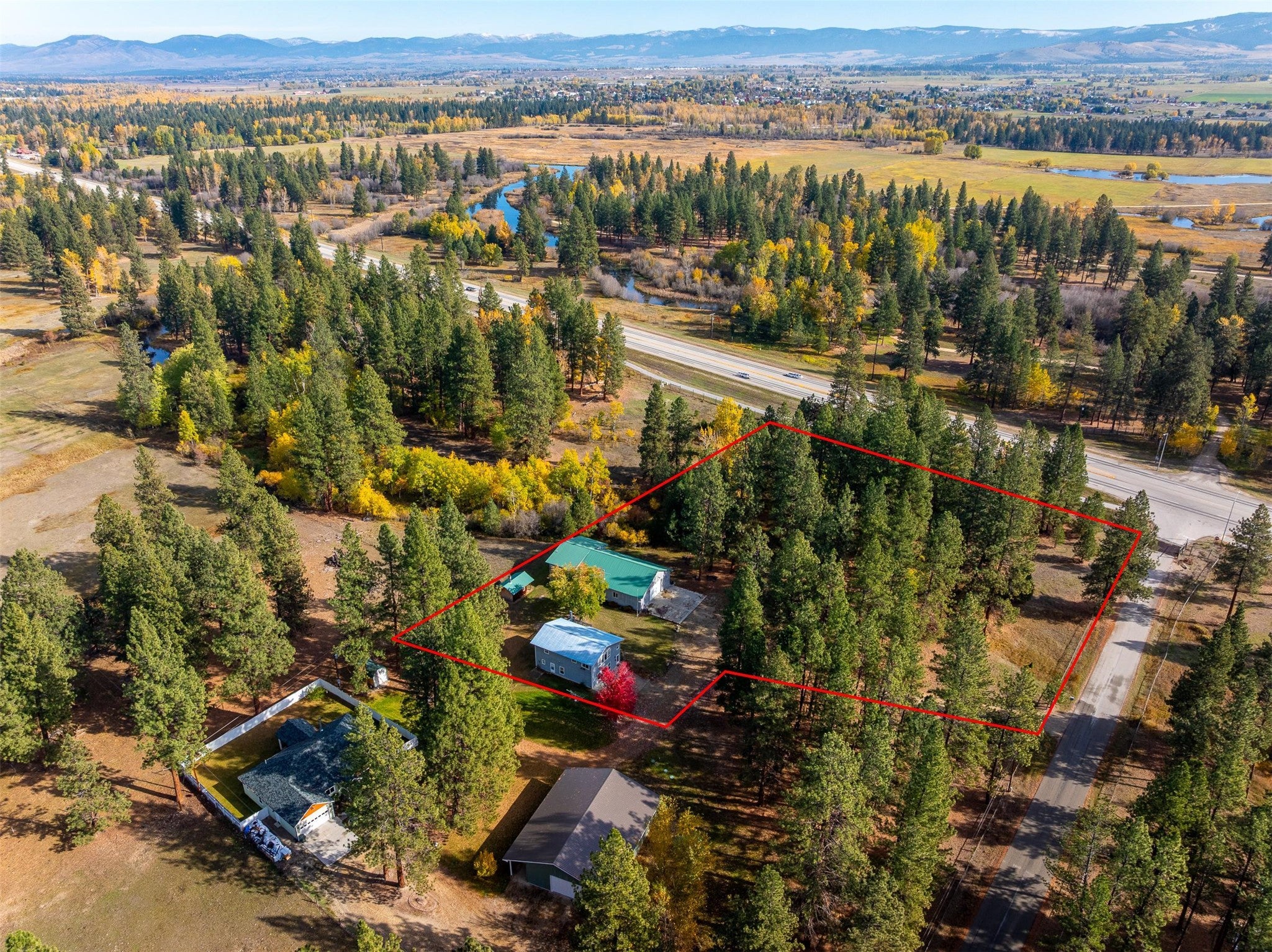 212 St Marys Road Stevensville, MT 59870 - Photo 2 of 39 Aerial overview of property's location with property parcel outlined and a mountain backdrop