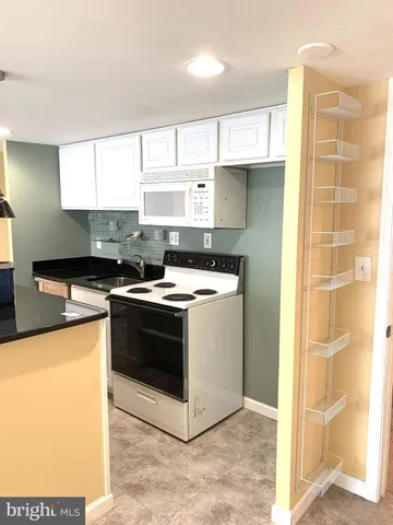 a kitchen with stainless steel appliances a stove a sink and a microwave
