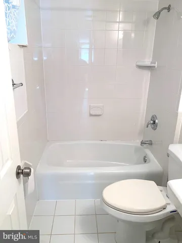 a bathroom with a toilet and a bath tub