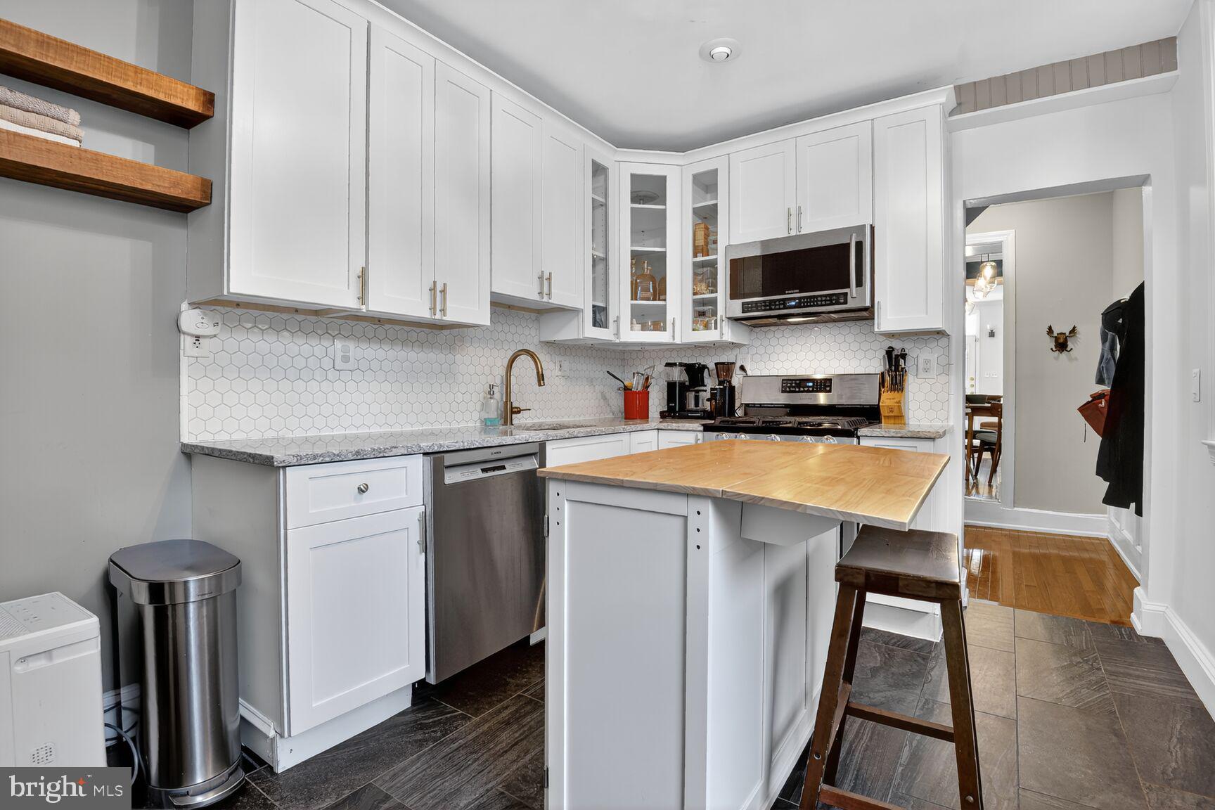 220 North Patrick Street Alexandria, VA 22314 - Photo 6 of 15 a kitchen with stainless steel appliances granite countertop a refrigerator sink and microwave