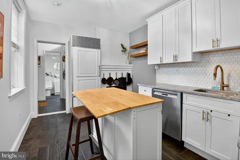 a kitchen with stainless steel appliances granite countertop refrigerator sink and cabinets