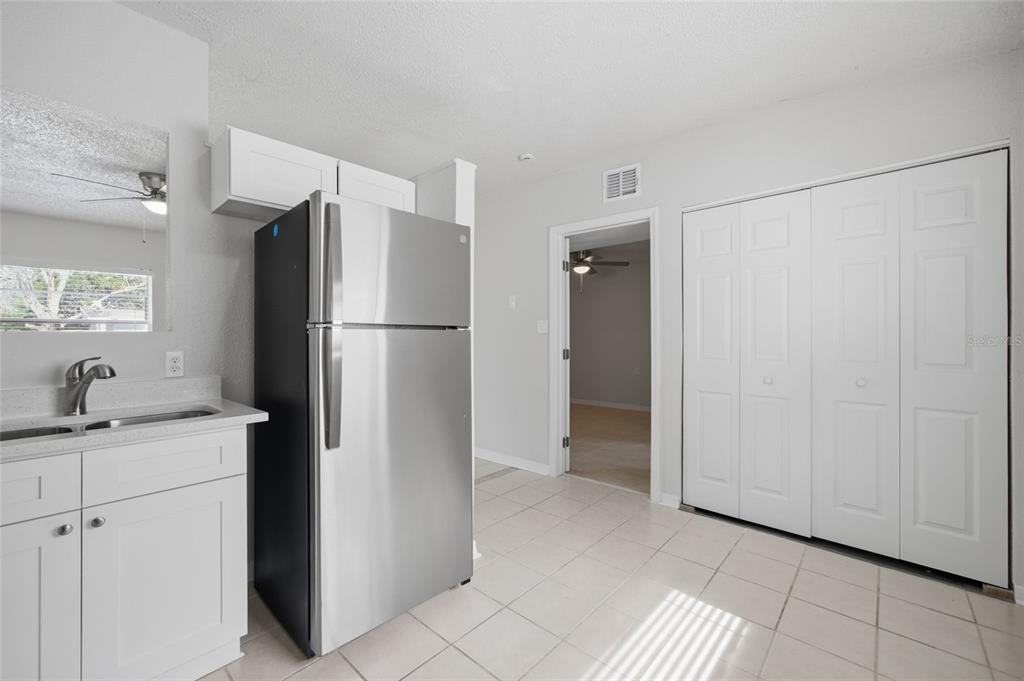 6629 Sierra Terrace New Port Richey, FL 34652 - Photo 7 of 30 a kitchen with a refrigerator and a sink