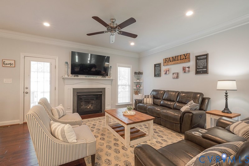 9425 Marie Road New Kent, VA 23124 - Photo 10 of 55 a living room with furniture a flat screen tv and a fireplace