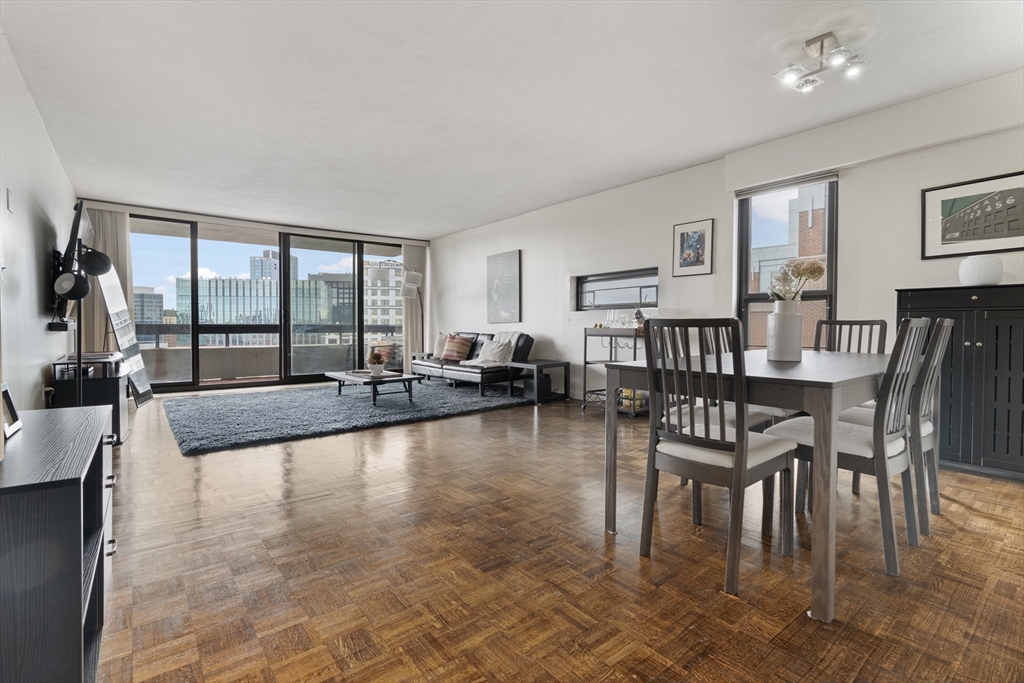 566 Commonwealth Avenue, Unit 1110 Boston, MA 02215 - Photo 2 of 13 a living room with fireplace furniture and a large window