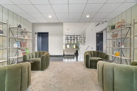 a living room with furniture a ceiling fan and a rug