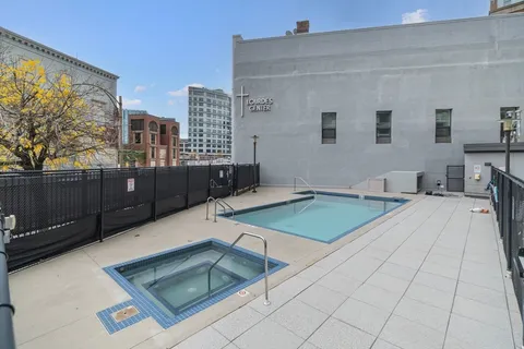 a room with pool table and windows