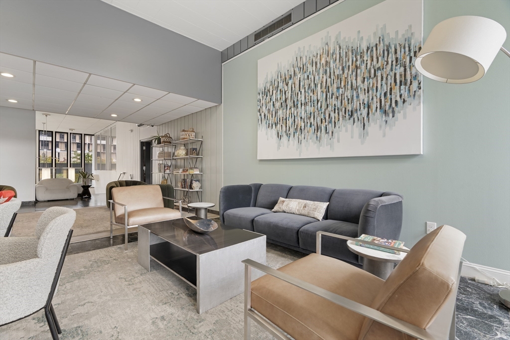 566 Commonwealth Avenue, Unit 1110 Boston, MA 02215 - Photo 10 of 13 a living room with furniture and a large window