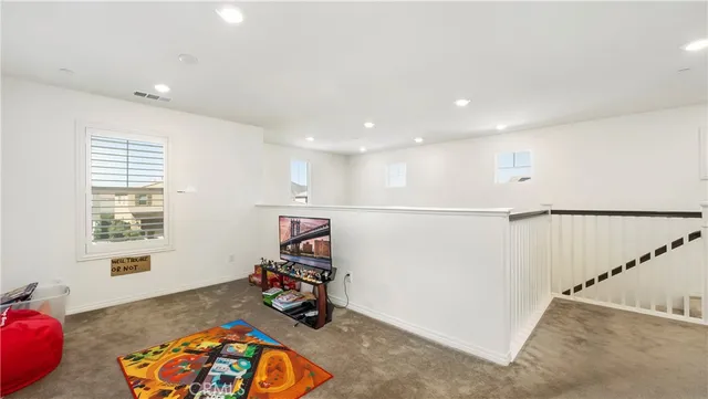 a view of a hallway with workspace and a window