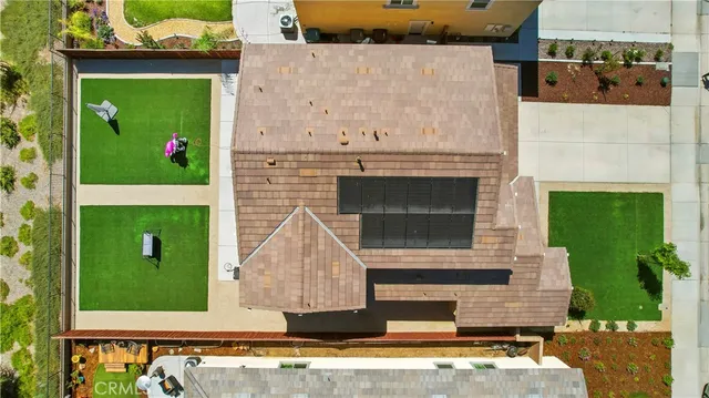 an aerial view of a house with a yard