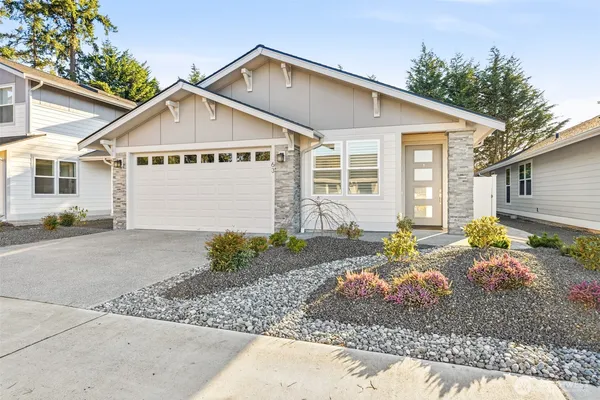a view of a house with a yard and garage