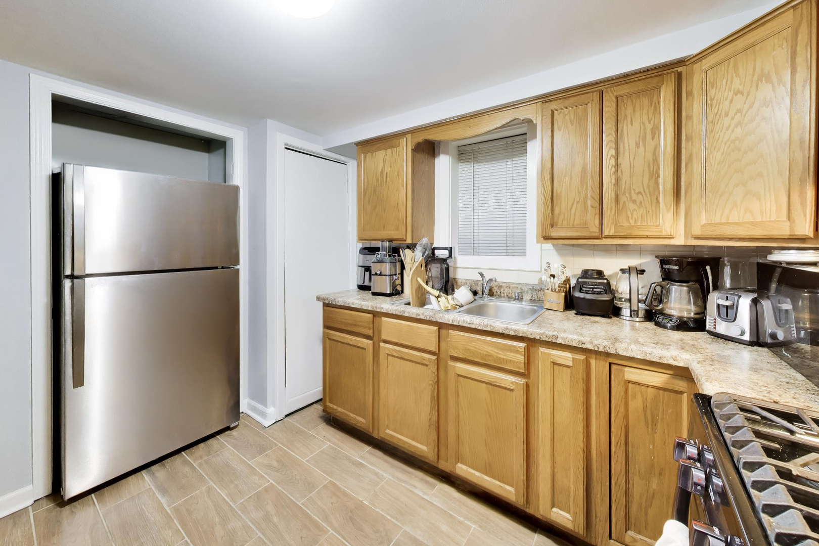 5057 West Dakin Street, Unit G Chicago, IL 60641 - Photo 13 of 19 a kitchen with stainless steel appliances granite countertop a refrigerator a sink and a stove