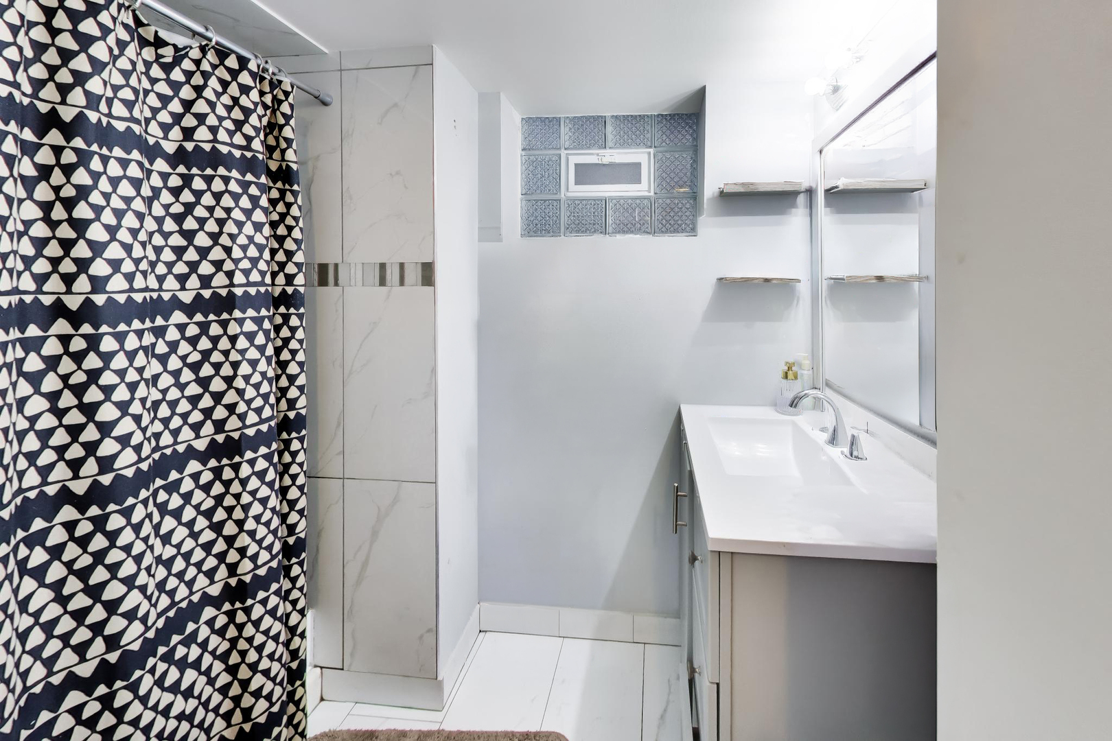 5057 West Dakin Street, Unit G Chicago, IL 60641 - Photo 14 of 19 a bathroom with a sink and mirror