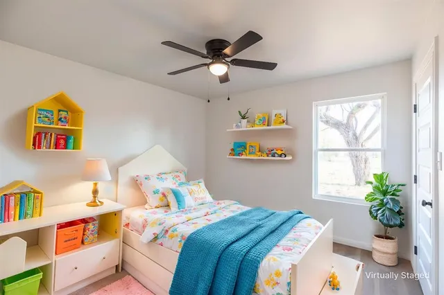 a bedroom with a bed and a window