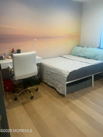 a bedroom with a bed and a desk in it