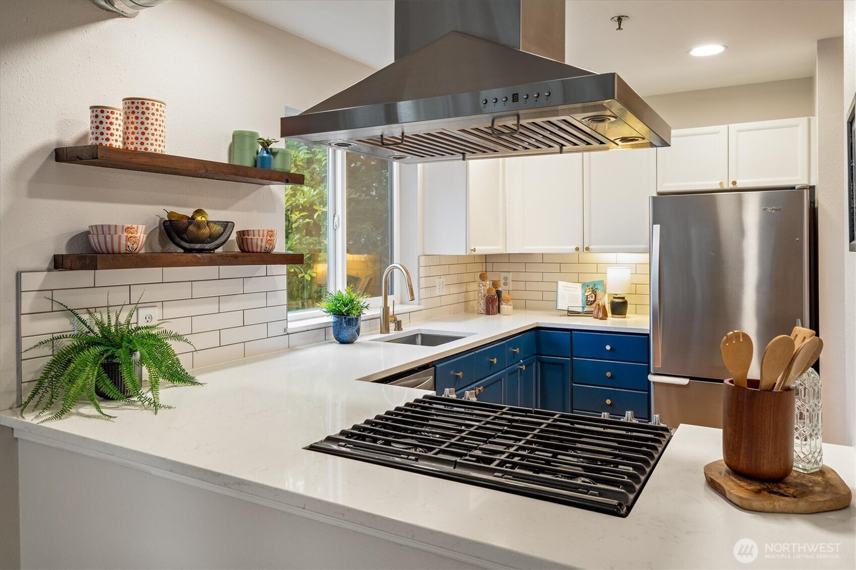 2024 Northwest 57th Street, Unit 201 Seattle, WA 98107 - Photo 12 of 29 a kitchen with stainless steel appliances a stove a refrigerator and a sink